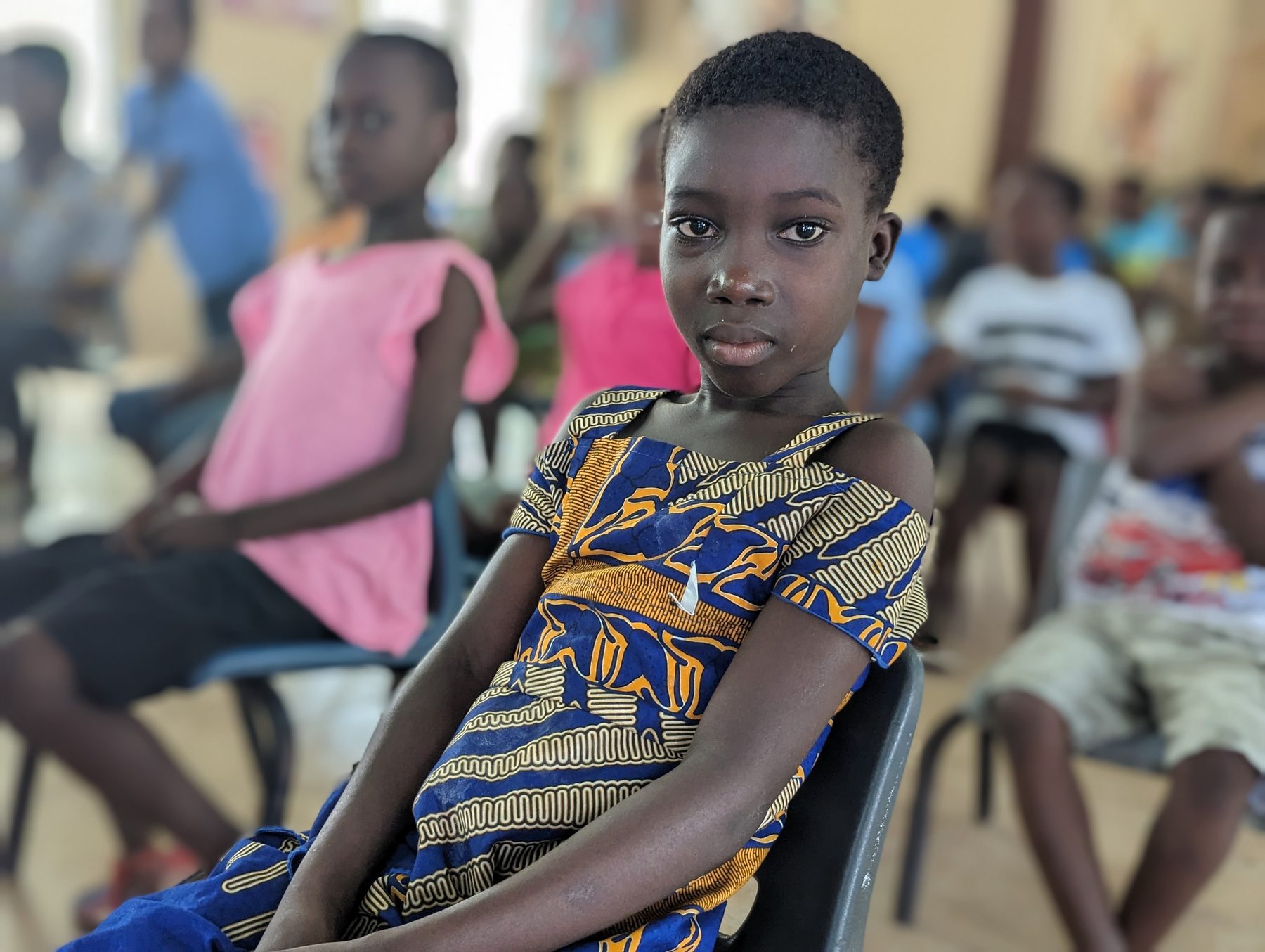 A child at Rafiki holding a gift